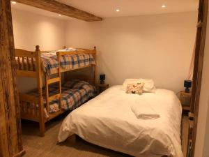 a bedroom with a bunk bed with a teddy bear on it at Chalet Chocolat Chatel in Châtel