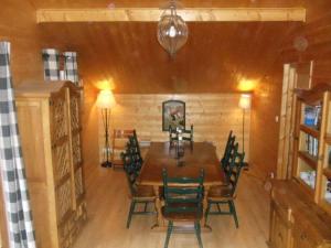 a dining room with a wooden table and chairs at Chalet Chocolat Chatel in Châtel