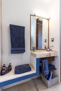 a bathroom with a sink and a mirror at Casa Laák´Fabulous rustic townhouse with pool in Mérida