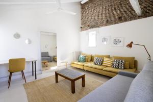 un soggiorno con divano e tavolo di apartamento el barrio de lavapies a Madrid