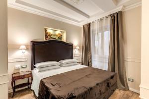 a bedroom with a bed and a window at Aurelius Ponte Sant'Angelo in Rome