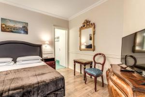a bedroom with a bed and a desk and a mirror at Aurelius Ponte Sant'Angelo in Rome