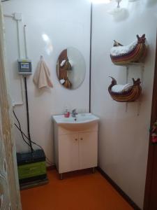 a bathroom with a sink and a mirror at TITICACA DELUXE LODGE in Puno