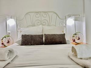 1 dormitorio con 1 cama blanca y 2 almohadas en Elva Creta, en Heraclión