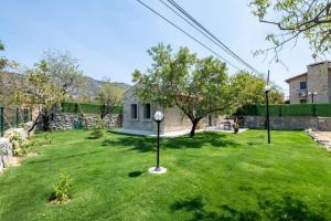 a yard with a clock in the grass at Stone Mini House Datça in Datca