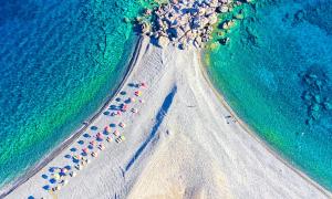 an overhead view of a beach with umbrellas at Art Apartment in Palaiochóra