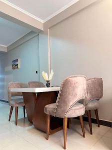 a dining room with a table and chairs at Cozy apartment in heart of Kampala in Kira