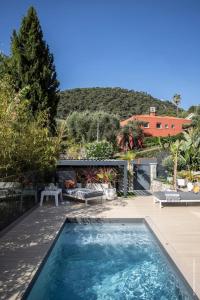 a swimming pool in the yard of a house at GROUND FLOOR VILLA GRAZIELLA 200 M FROM THE BEACH in Èze