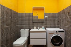 a bathroom with a washing machine and a washer at Hostel StepIn in Kutaisi