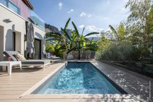 a swimming pool in the backyard of a house at GROUND FLOOR VILLA GRAZIELLA 200 M FROM THE BEACH in Éze