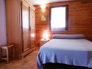 a bedroom with a bed in a wooden room at Les aubepines in Brocas