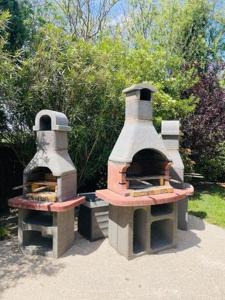 two outdoor ovens sitting next to each other at Les Cyprés in Saintes-Maries-de-la-Mer