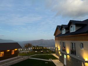 a house with a view of the mountains at night at Chestnut Hill in Kolgecaj