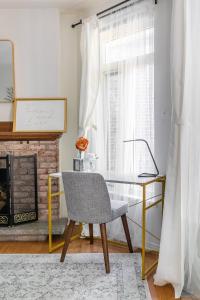 a desk and a chair in a room with a fireplace at Sweet Home in Toronto