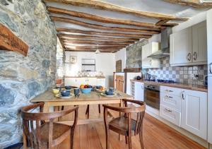 a kitchen with a wooden table and two chairs at The Crown in Dolgellau