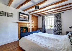 a bedroom with a large bed and a fireplace at The Crown in Dolgellau