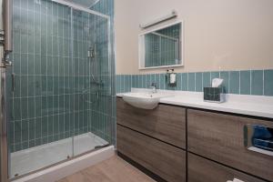 a bathroom with a sink and a glass shower at The Tynemouth Castle Inn - The Inn Collection Group in Tynemouth