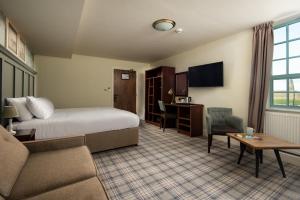 a hotel room with a bed and a desk at The Tynemouth Castle Inn - The Inn Collection Group in Tynemouth