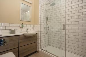 a white bathroom with a sink and a shower at The Tynemouth Castle Inn - The Inn Collection Group in Tynemouth