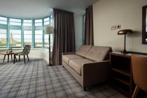 a living room with a couch and a table at The Tynemouth Castle Inn - The Inn Collection Group in Tynemouth