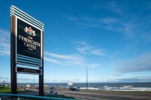 a sign on the side of a road near the ocean at The Tynemouth Castle Inn - The Inn Collection Group in Tynemouth