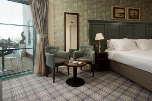 a hotel room with a bed and a table and chairs at The Tynemouth Castle Inn - The Inn Collection Group in Tynemouth