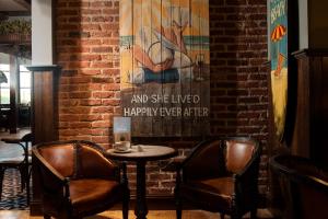 a brick wall with a table and two chairs at The Tynemouth Castle Inn - The Inn Collection Group in Tynemouth