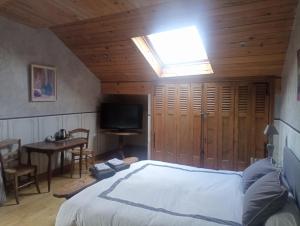 a bedroom with a bed and a skylight at Villanath in Bellegarde-sur-Valserine