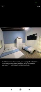 a picture of a bedroom with two beds at Quédate con Marcel in Cali