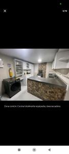a kitchen with a stove and a stone counter top at Quédate con Marcel in Cali