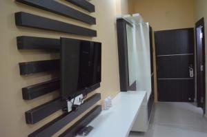 a television on a wall in a bathroom at HOTEL MARIYA INTERNATIONAL in Bodh Gaya