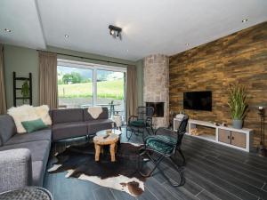 a living room with a couch and a fireplace at Chalet Schneelöwe XL in Leogang