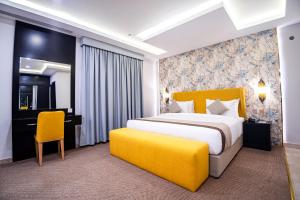 a hotel room with a large bed and a desk at DAM hodoo دام الهــــــــدوء in Al Khobar