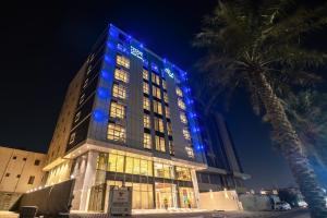 a building with blue lights on it at night at DAM hodoo دام الهــــــــدوء in Al Khobar