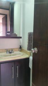 a bathroom with a sink and a mirror at Habitación en apartamento compartido en Envigado in Envigado