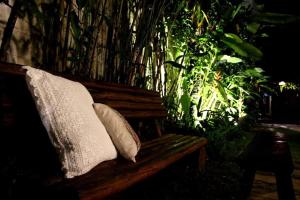 two pillows sitting on a wooden bench with plants at Villa de Bemposta-Trancoso in Trancoso