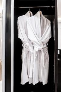 a white robe is hanging in a closet at DAM hodoo دام الهــــــــدوء in Al Khobar