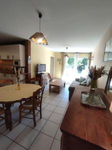 een woonkamer met een tafel en een bank bij Gîte rural le Rouchassier in Saint-Laurent-du-Cros