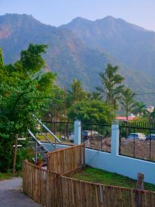 a fence with a view of a mountain at Flow House in Rishīkesh