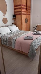 a bedroom with a large bed with a mirror at ΩκεανιςHouse 1 in Preveza
