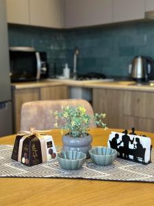 a table with two bowls and a picture of a family at Downtown Apartment in Kutaisi