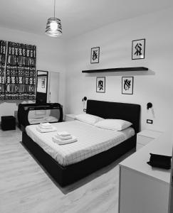 a black and white bedroom with a large bed at Black&White guest house in Iglesias