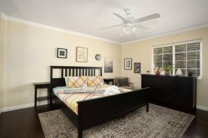 a bedroom with a bed and a ceiling fan at Charming 4BR Retreat - Near Old Town Monrovia in Monrovia