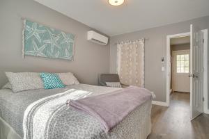 a bedroom with a bed and a chair at about 1 Mi to Beach Cape Cod Apt in South Yarmouth in Yarmouth