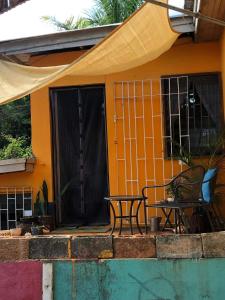 a table and chairs on a porch of a house at BnB SoMom Mobay Lodging in Montego Bay