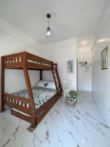 a bedroom with a wooden bunk bed in a room at The Kroun Seafront Residences 