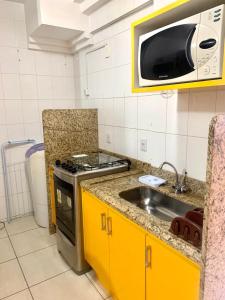 cocina con fregadero y microondas en Flats Residence Bueno, en Goiânia