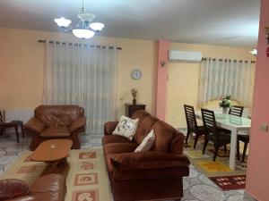 a living room with a couch and chairs and a table at Lovely flat in the heart of Korca #1 in Korçë