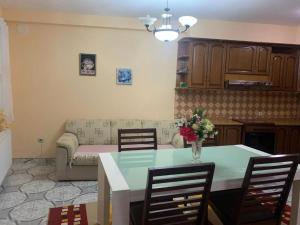 a living room with a table and a couch at Lovely flat in the heart of Korca #1 in Korçë