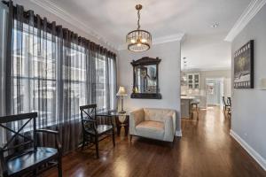 a living room with a table and chairs and a chandelier at Luxury Home near Wrigley, Boystown & Andersonville in Chicago